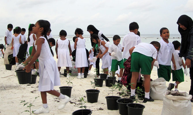 Group of children with tree saplings