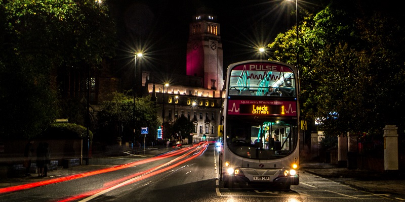 Night scene showing Leeds city centre double decker bus