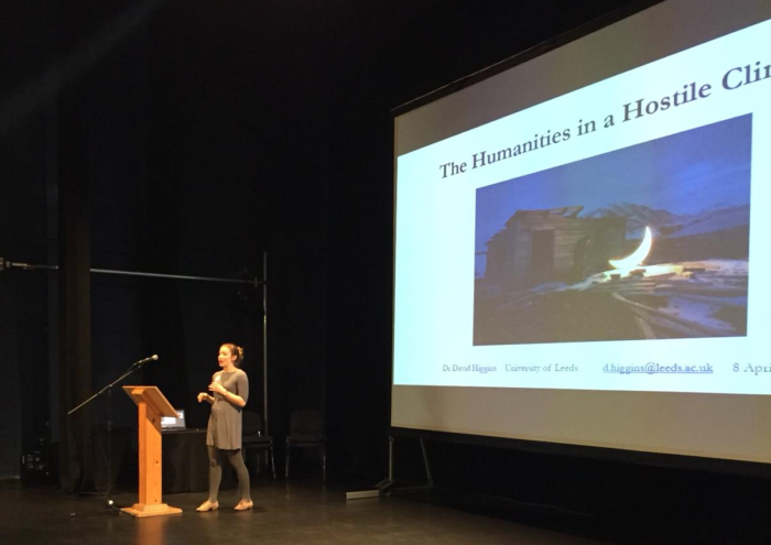 Podium image of Isabel Cook standing in front of a presentation slide