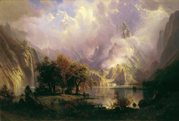 Painting of a rocky mountain landscape, with trees and vegetation in the foreground by Albert Bierstadt