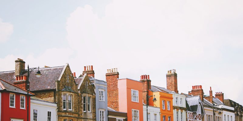 A row of houses with different coloured frontages