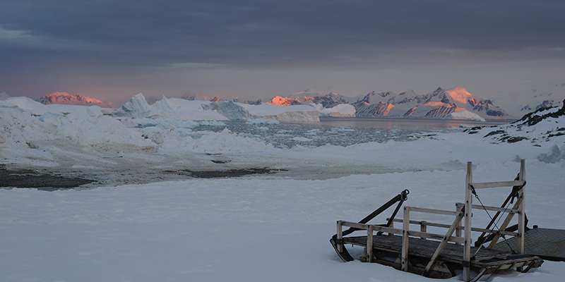 Sled on the ice at sunset