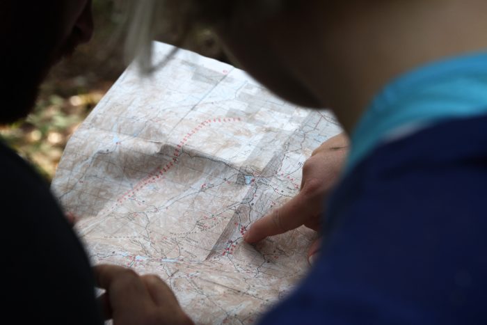 Close-up of people reading a map