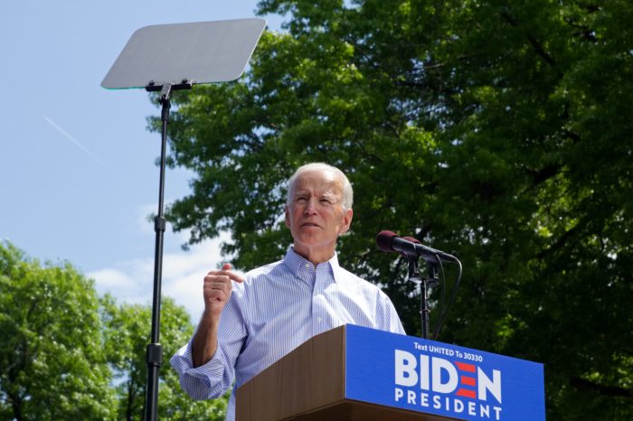 President Biden stands on podium talking