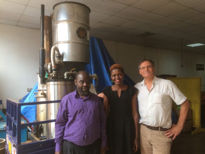University of Leeds and CREEC collaborators standing in front of a mobile gasifier electricity generator during a meeting to discuss energy access for blind people.