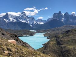 snow-capped mountains standing behind a blue lake
