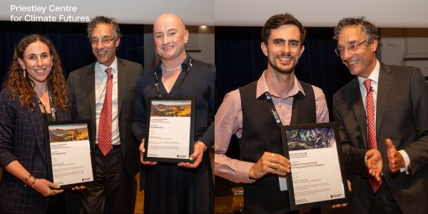 Piers forster stands with the prize winners holding certificates